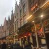 String lights cover the buildings near the Brugge Christmas market