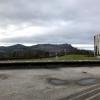 The view of mountain tops are seen from the outside of a cafe