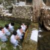 Buddhist monks sitting in the water to show their devotion and pray, while the temperature outside is below freezing