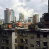 Tall buildings in the city center with some older apartment blocks closer up