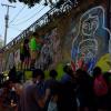 Look at all the people coming together to paint and help create a public mural