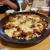 Jjimdak, spicy Korean braised chicken and vegetables under a layer of melted cheese