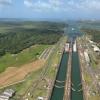 Human-made locks connect the Caribbean Sea with the Pacific Ocean, with ships passing through Gatun Lake in the middle 