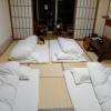 A traditional style hotel room with tatami mat floors and futons for beds