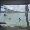 Small fishing boats are anchored below El Puente de Las Americas, the Bridge of the Americas. It gets its name because it spans the Panama Canal, with North America to the north and South America to the south
