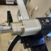 The optical coherence tomography device uses light waves to create 3D images of the bactera growing on the anode disk in the MEC