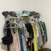 My clothes hanging on their rack