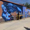 Artist creating wall art in Mitla