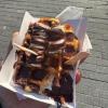 A Belgian waffle with dark chocolate and bananas