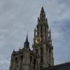 A medieval clock tower looks over a square in Antwerp