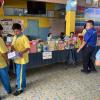 Older students and teachers helped younger students find the gifts that they had won in the student raffle