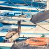So many birds around the pier. A pelican minding one of the fishing boats.