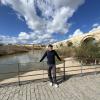 This is a picture of me in Cordoba, Spain. In the background there is a bridge from the Roman Empire built over 1600 years ago. 