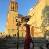 Near the Templo de Santo Domingo de Guzmán, a towering Catrina, dressed in elegant red, stood proudly, embodying the grace, tradition and spirit of Día de los Muertos in Oaxaca