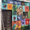 A mural in Amman titled "Society" in Arabic captures notable features of Jordanian history, nature and life