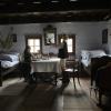 Inside of an old Slovak house...the hanging fabric above the bed is where babies used to sleep!