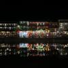 The river in Hoi An at night, with a view of some illuminated markets