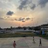 Kids playing soccer at sunset