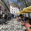 A downtown view of Lisbon, where restaurants and outdoor seating make the area feel lively and social.