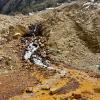 Water affected by Acid Rock Drainage flowing through a landslide area