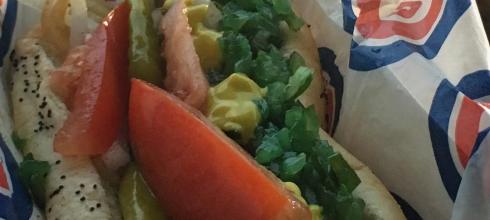 Chicago is known for its great food such as a famous hot dog with sport peppers, celery salt, tomatoes, onions, and mustard!