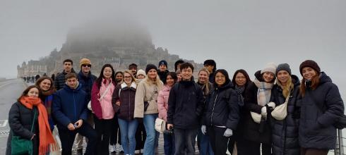 A group photo of me with Erasmus students in front of Le Mont-Saint-Michel