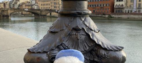 Signor Gufo poses by the River Arno in Florence