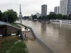 A flooded walkway in Paris, with the Eiffel Tower in the background (Photo from PxHere)