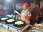A market vendor cooking omelettes