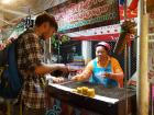 This woman sells yummy grilled egg and rice patties