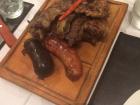 This is what a typical platter of asado looks like: filled with ribs, sausage and steak