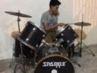 Mauro playing his drums outside of his house