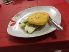 Arepas come in all shape, sizes, and types. Here's a Venezuelan one: it has food in the center. Here's one Antonin made, and he has taught me how to make them myself!