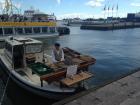 Selling fish off a boat at the Market Square