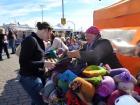 A woman sells her knitting at the Market Square
