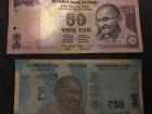 To make it harder to make counterfit money, the Indian government changes the money designs every couple years. These IR 50 bills have the same value and different sizes, colors, security markings, etc.
