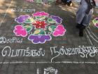 The students who made this kolam for the school competition wrote their Pongal message in Tamil