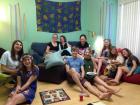 Having fun playing a board game with some college friends