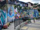 A long graffiti mural along a main walkway in Comuna 13