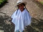 A young Sofia shows off her traditional poncho and hat