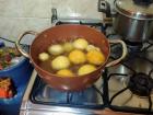 Buñuelos frying in the pan, at different stages of readiness 
