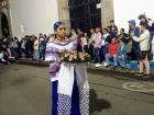 During a religious Easter procession in Popayán, a woman carries burning incense 