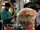 A pani puri cart stacked high with puris