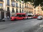 A row of buses in a busy part of the city near my school