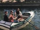 A few of my friends in a row boat going around the small river in the Spanish Plaza