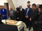 Religious and community leaders cut the vasilopita at a local New Year's celebration
