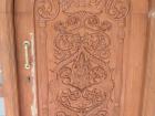 The door to the house was beautifully carved out of wood.