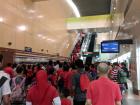 A queue up the escalator on National Day, where everyone wore red as well