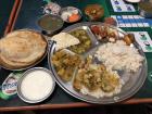 I went to a small hole-in-the-wall restaurant in Pokhara with friends and ate this huge meal of dal bhat