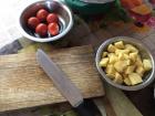 Chopping up potatoes and tomatoes for evening dal bhat